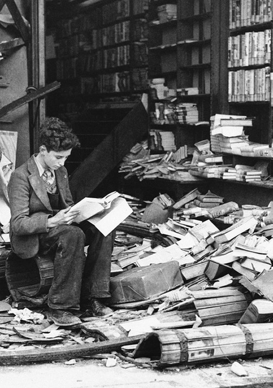 +327 A boy sits reading in a bombed bookstore, London, October 8 1940.jpg